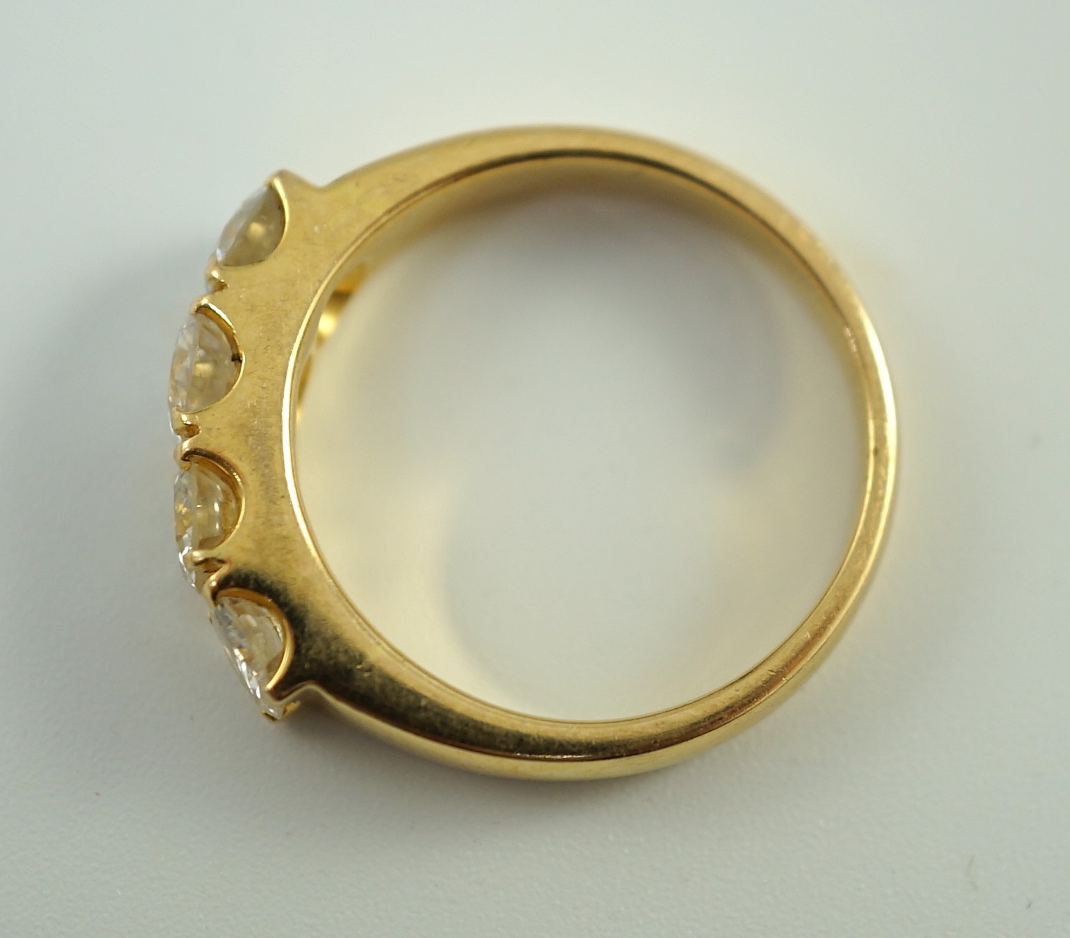 A modern 750 gold and four stone diamond set ring